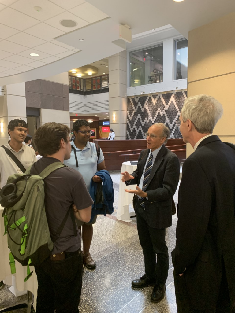 The presenter talks with students after its concluded