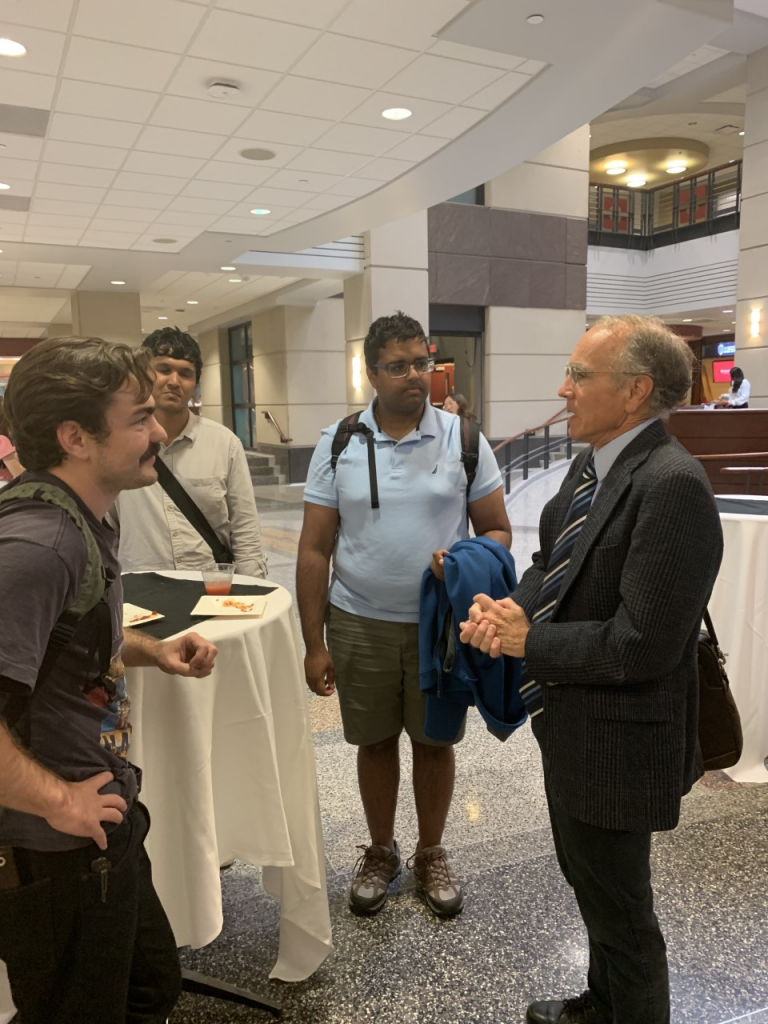 The presenter talks with students after its concluded