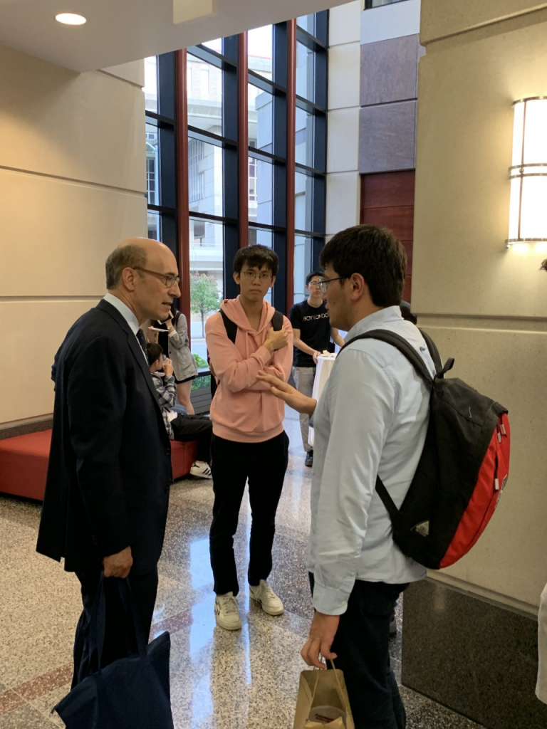 Presenter rogoff talks with students after finishing his presentation