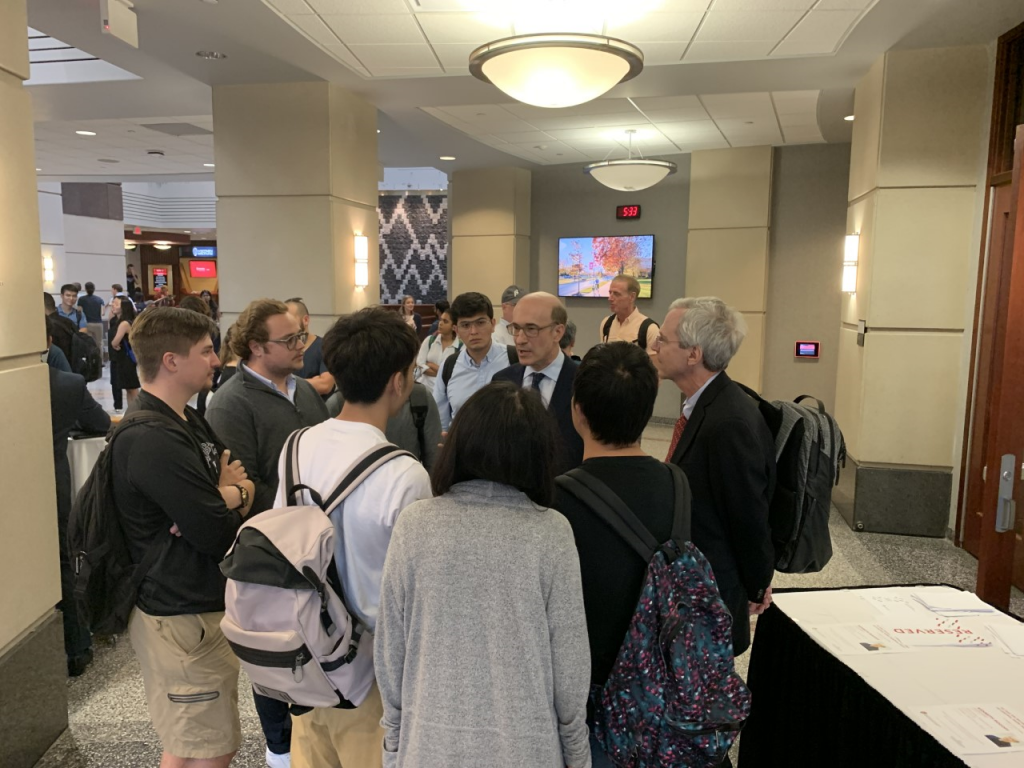Presenter Rogoff talks with students after finishing his presentation