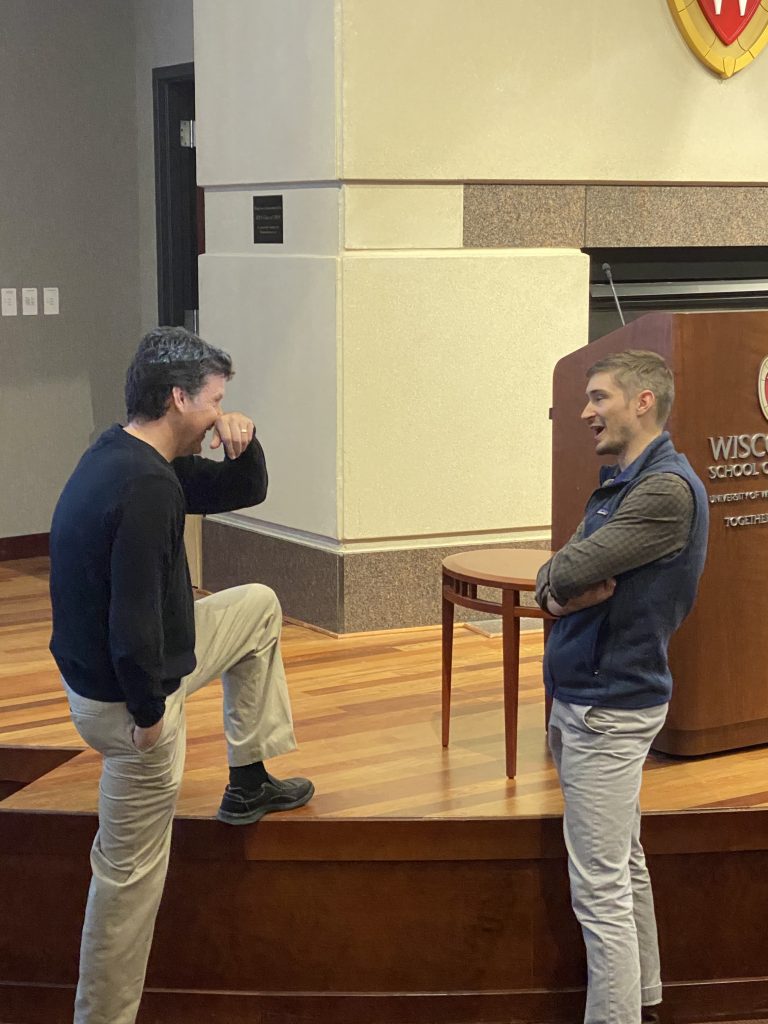 speaker talks with person following a presentation