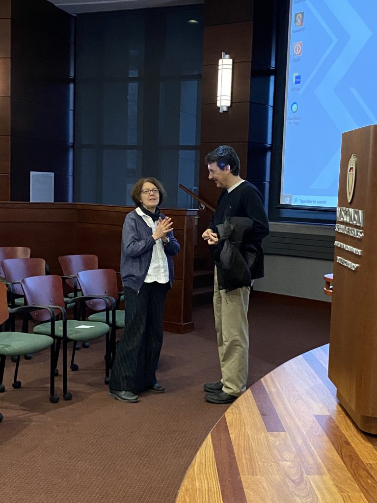 person talks with speaker after their presentation