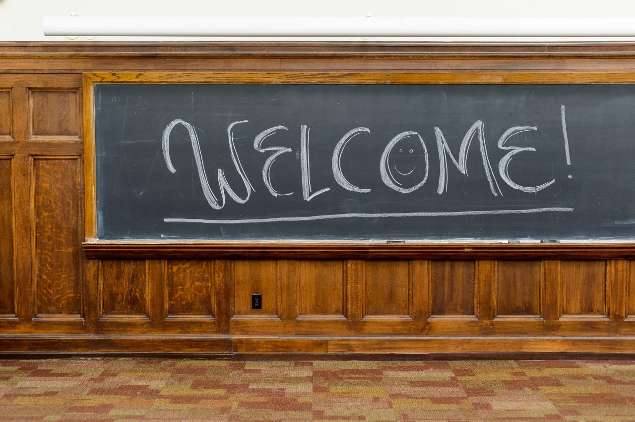 u0027welcomeu0021u0027 written in chalk on a black chalkboard